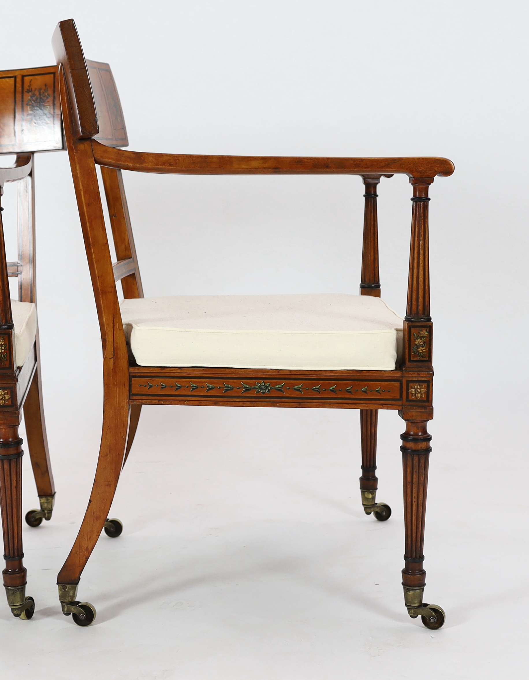A pair of Edwardian Sheraton revival painted satinwood elbow chairs, 58cm wide, 57cm deep, 88cm high